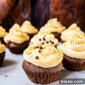Boozy Baileys Salted Caramel Cupcakes with a delicious chocolate Sponge! Sprinkled with chocolate balls and caramel crunch.