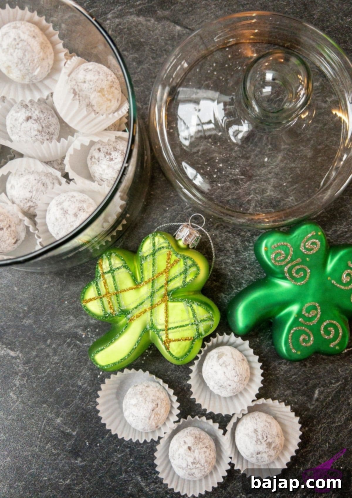 Homemade Baileys Chocolates ready to eat in a glass bowl next to two shamrocks