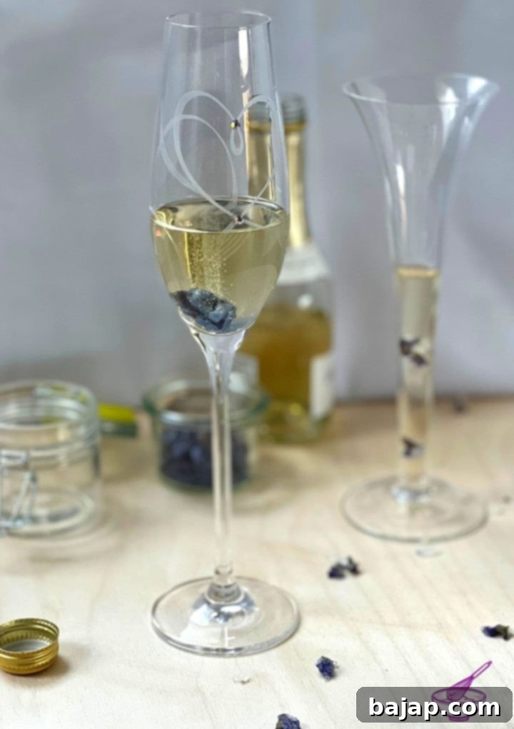A festive table setting featuring sparkling wine with candied violets, ready for celebration.