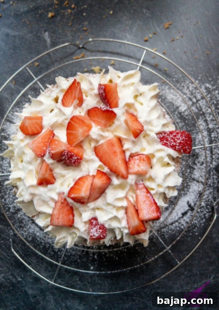 Strawberry Cloud Cake 6 Strawberry sponge cake with whipped cream and strawberries, ready for the next layer.