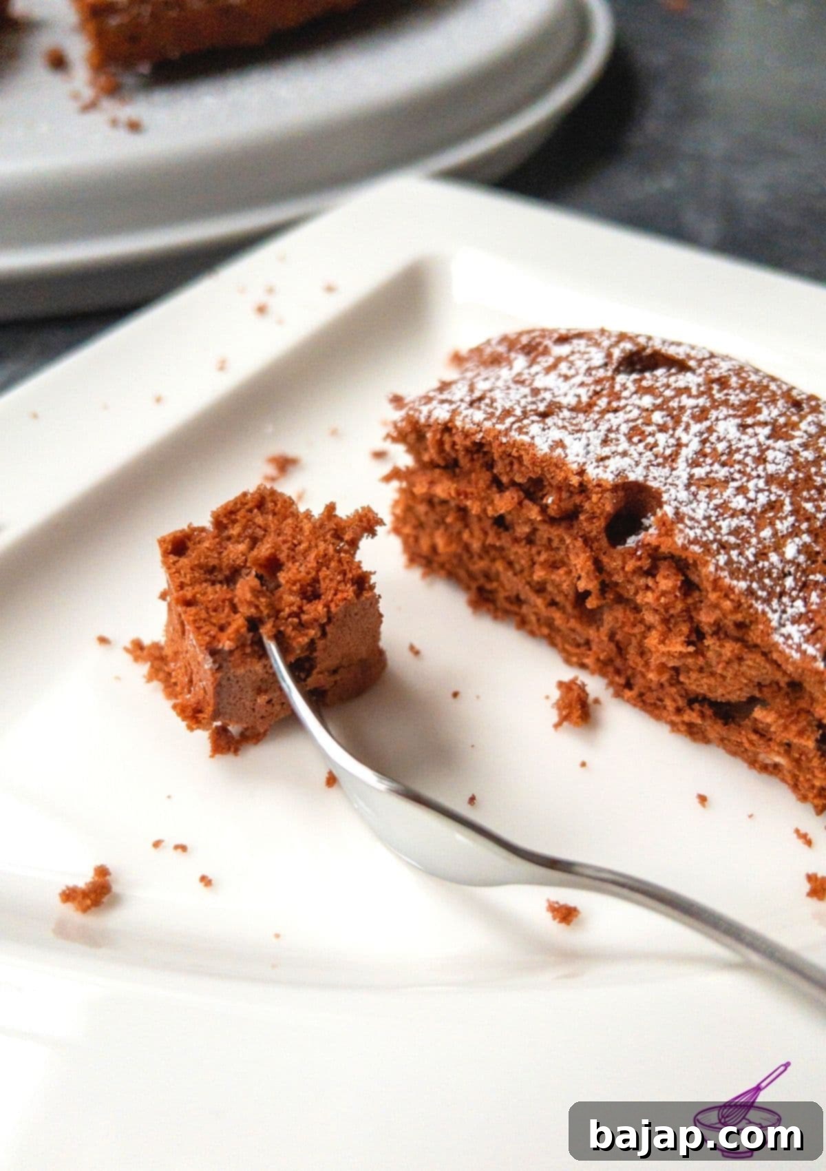 Delicious chocolate egg whites cake, beautifully sliced and dusted with powdered sugar, ready to be served.