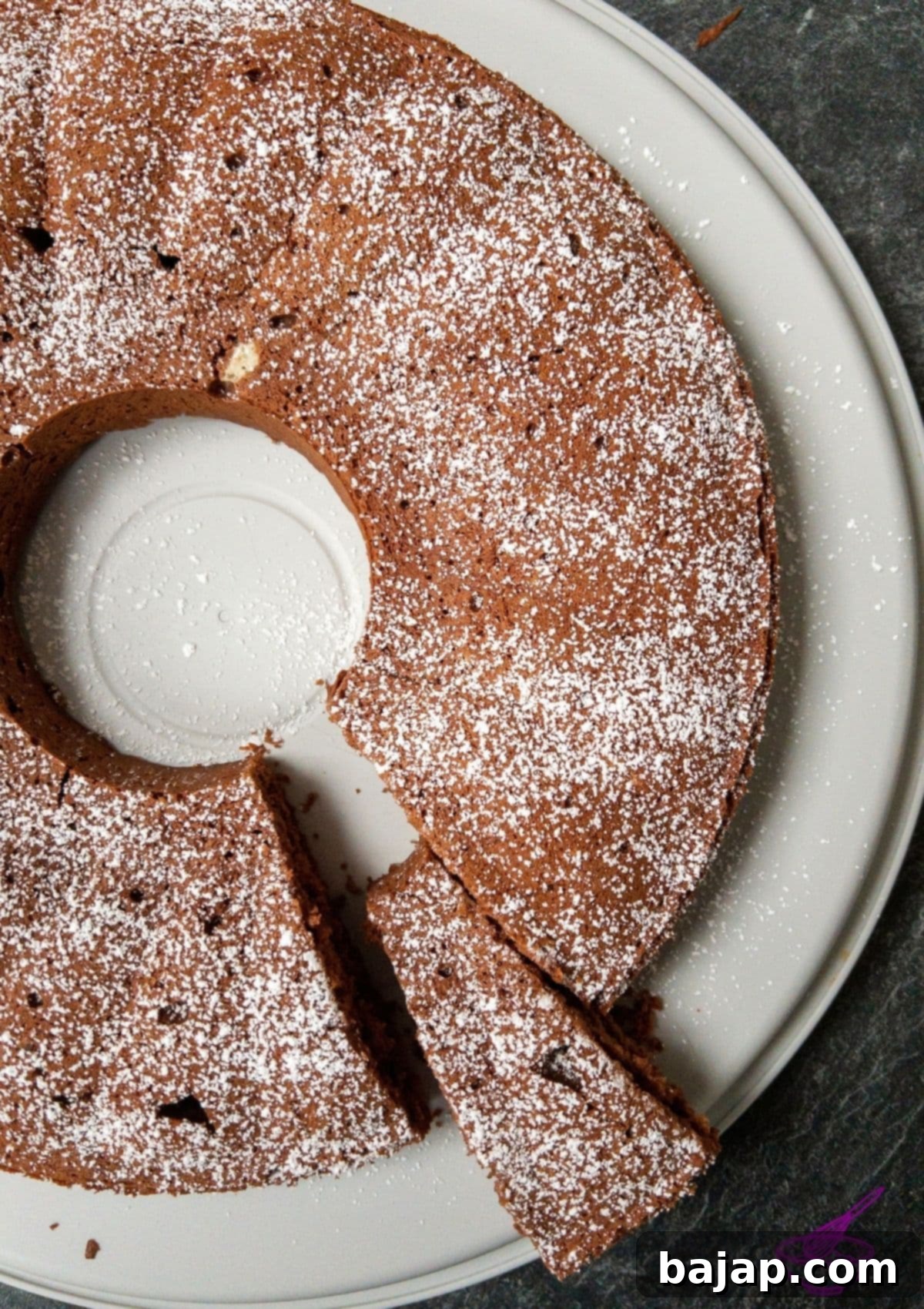 Dark chocolate couverture and unsalted butter melting in a double boiler for a smooth, rich cake batter base.