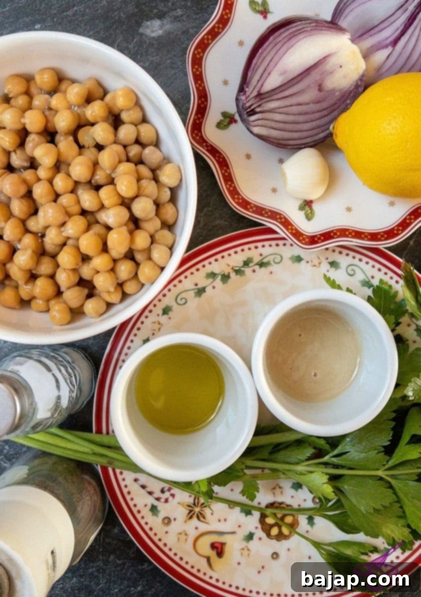 Fresh ingredients for homemade hummus laid out on a wooden board.