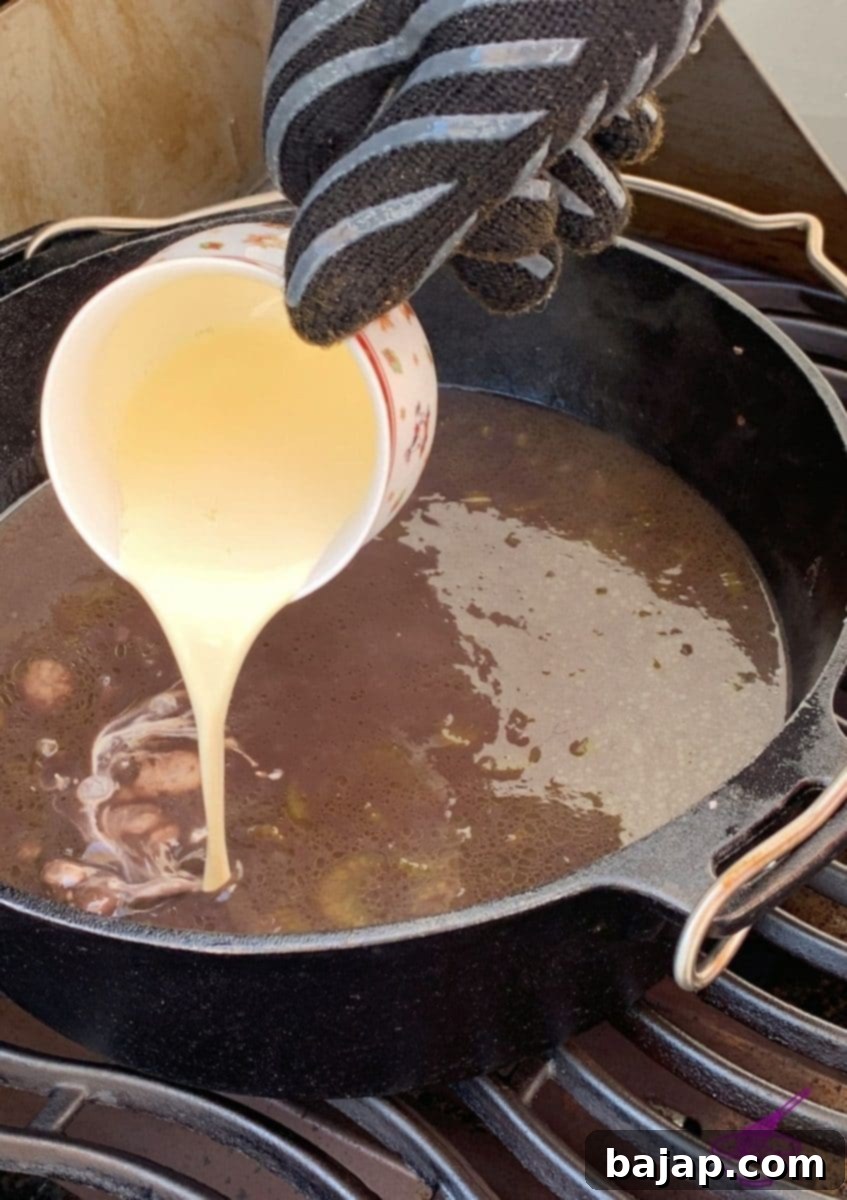 The finished chestnut and porcini mushroom soup simmering in the Dutch oven, with cream and cinnamon added.