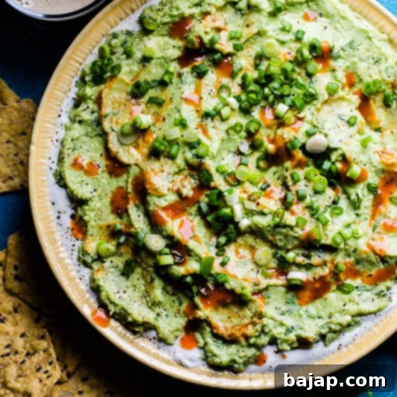 Avocado Greek Yogurt Dip with Buffalo Sauce layered in a glass.
