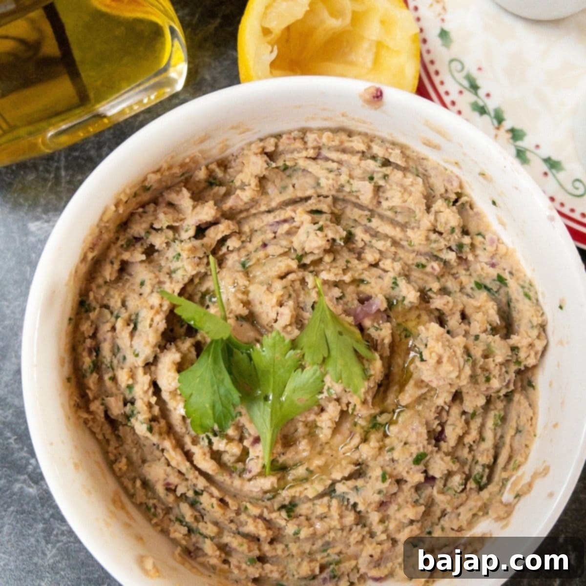 Homemade Chickpea Spread (Hummus) in a bowl with a spoon.