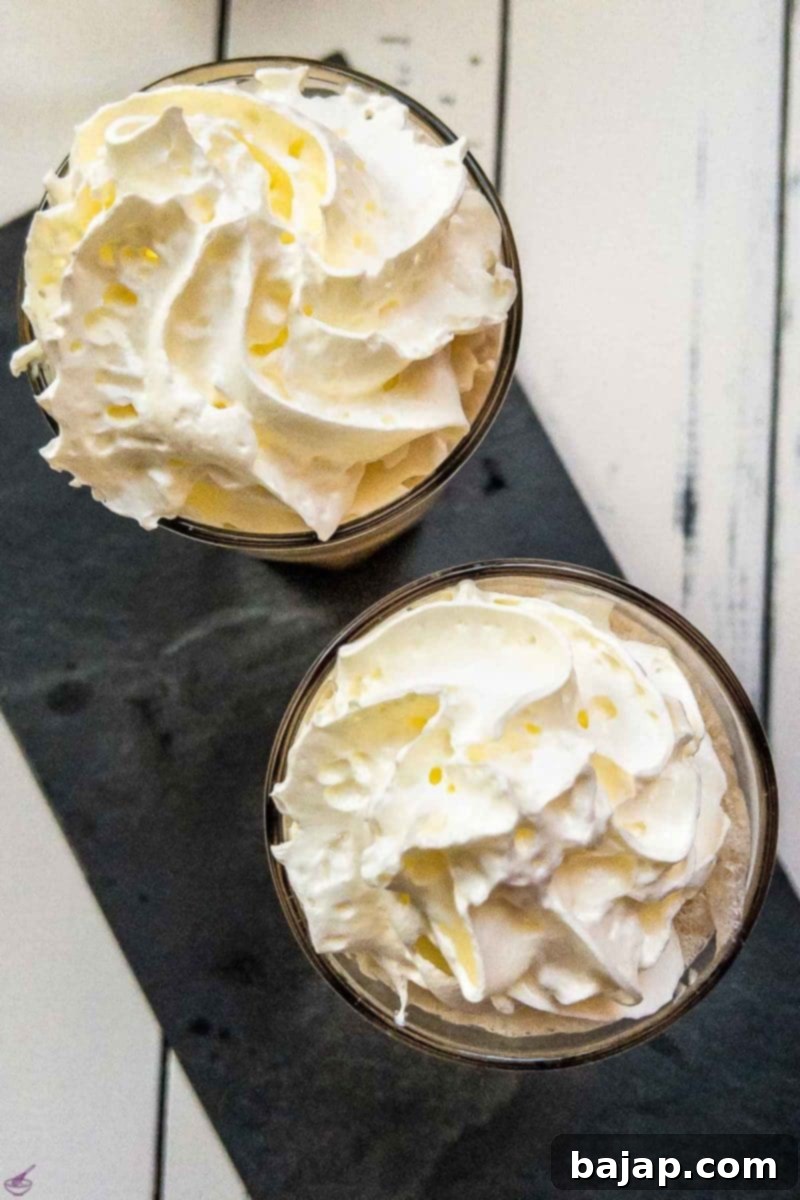 Garnish the stirred iced coffee with a generous dollop of whipped cream.