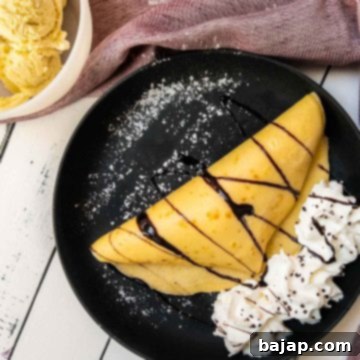Thin pancake dough, filled with delicious vanilla bean ice cream, drizzled with chocolate sauce, and refined with whipped cream and chocolate sprinkles!