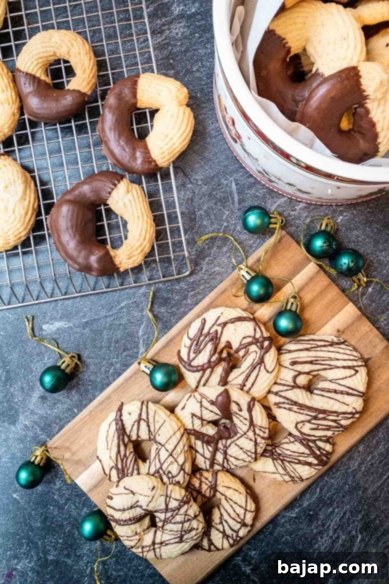A selection of chocolate-drizzled and chocolate-dipped butter cookies artfully arranged and ready to eat, highlighting their delicious appearance.