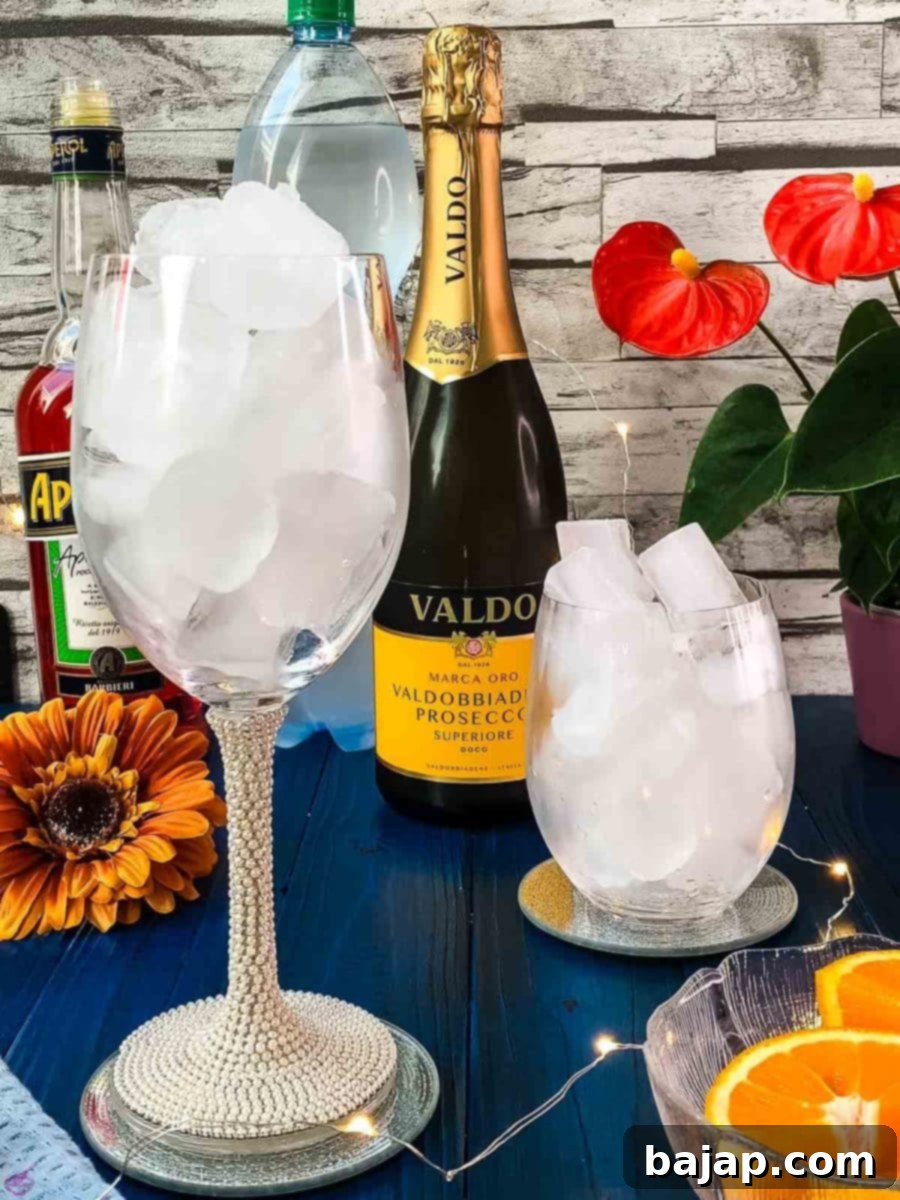 Fill the glasses with cubed ice for your Aperol Spritz.