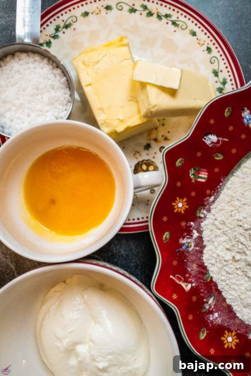 Three main ingredients for making sour cream cookies - butter, flour, sour cream. Egg yolk and nib sugar for decoration purposes. 