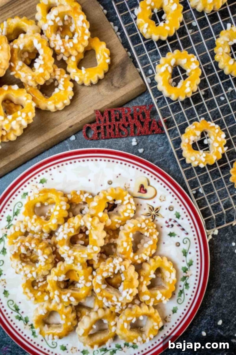 Close-up of baked sour cream cookies, golden with melted pearl sugar on top, showcasing a perfect texture for festive enjoyment.