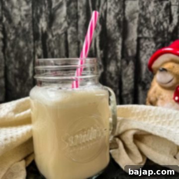 Easy 2 Ingredient Caramel Milk 9 Drinking glass with plastic straw and ready to drink caramel milk.