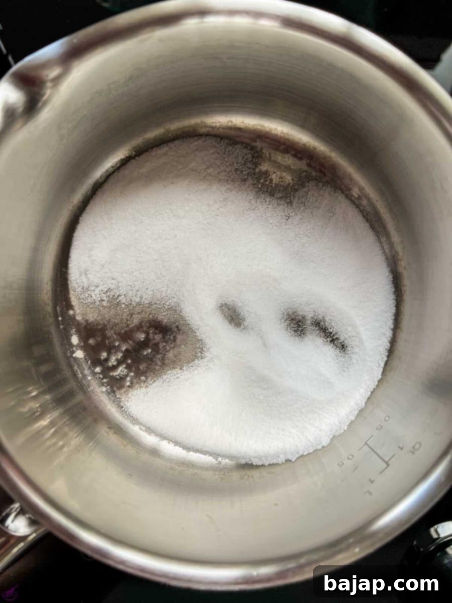 Easy 2 Ingredient Caramel Milk 5 Saucepan - The sugar starts to liquefy.