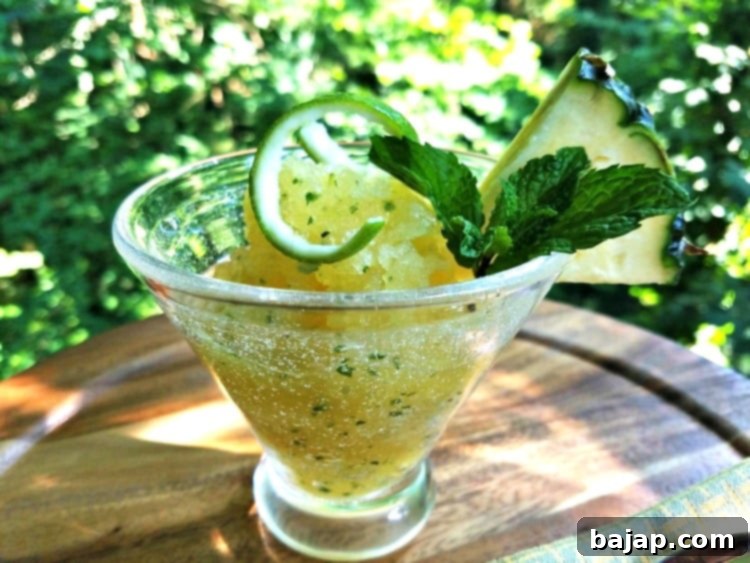 A bowl of refreshing pineapple granita, garnished with fresh mint.