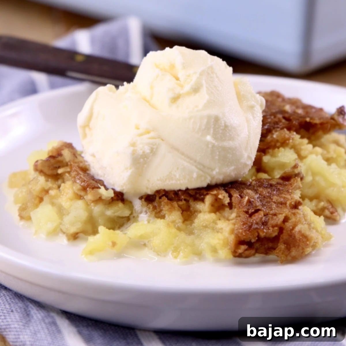 A baked pineapple dump cake in a casserole dish, topped with a golden crust.
