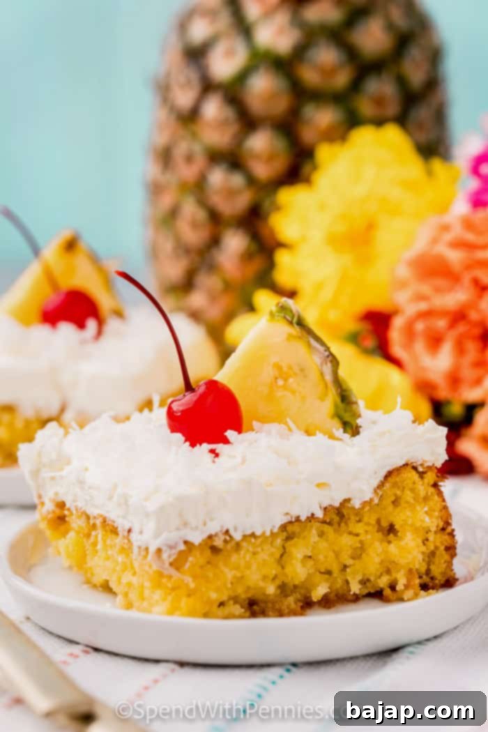 A whole Pina Colada cake topped with whipped cream and toasted coconut.
