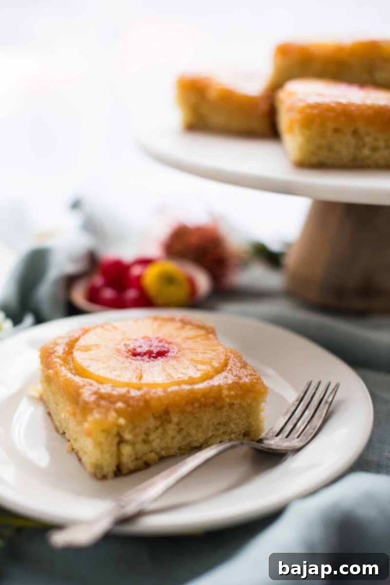 A large pineapple upside down cake with pineapple rings and cherries.