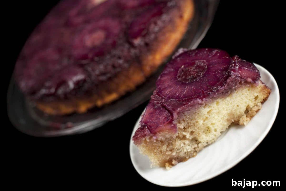 A French Martini Upside-Down Cake, showcasing a beautiful pineapple and cherry topping.