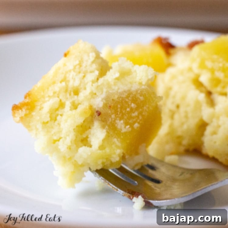 A slice of low-carb pineapple upside down cake, showing the caramelized pineapple topping.
