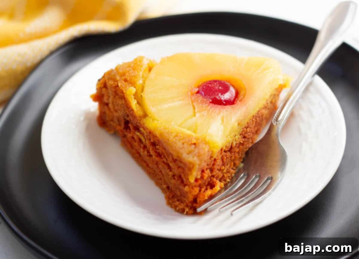 A vibrant vegan pineapple upside down cake, featuring caramelized pineapple and cherries.