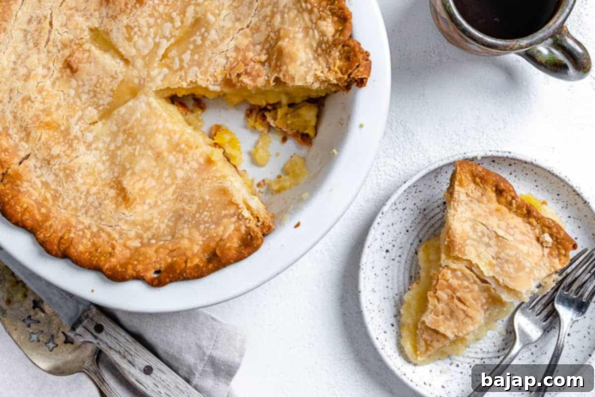 A slice of vegan coconut pineapple pie with a creamy filling.