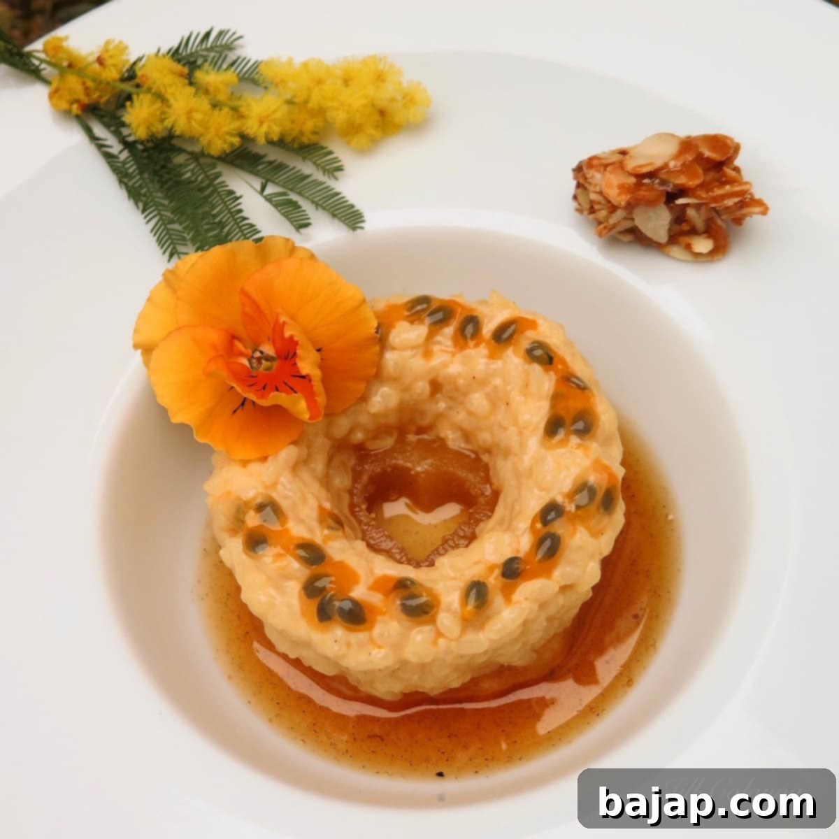 A serving of caramelised pineapple rice pudding, garnished with fresh fruit.