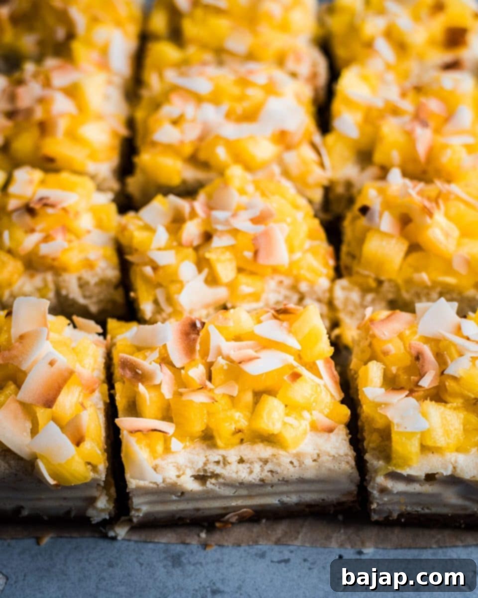 A plate of vegan Piña Colada cheesecake bars, garnished with toasted coconut.