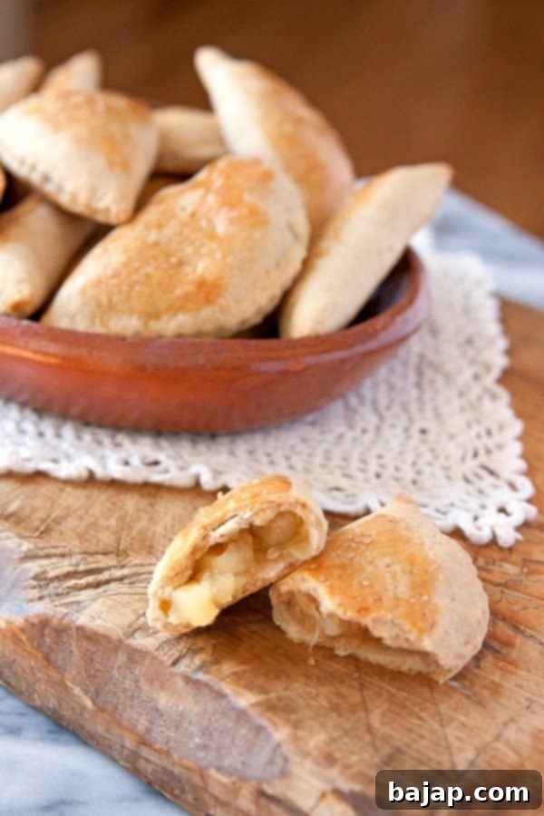 Delicious pineapple empanadas on a rustic wooden surface.