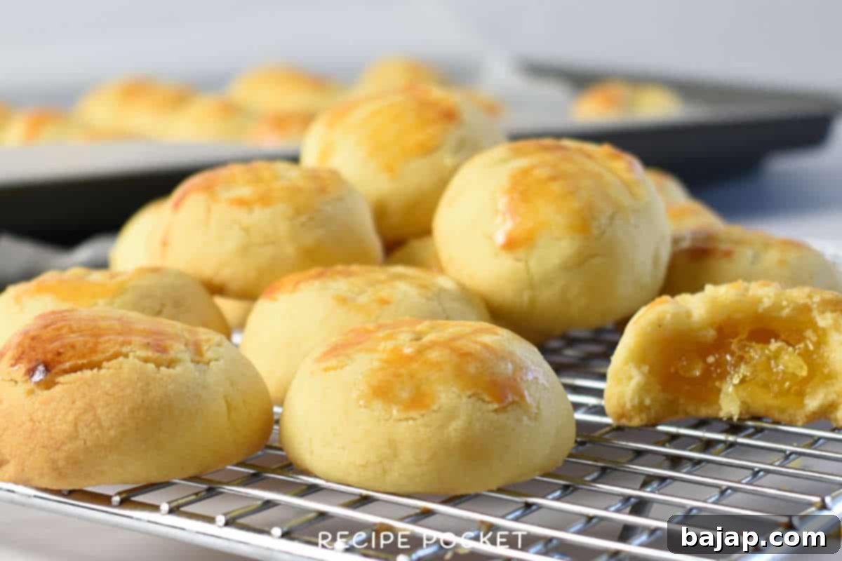 Assortment of golden-brown pineapple tarts on a plate.
