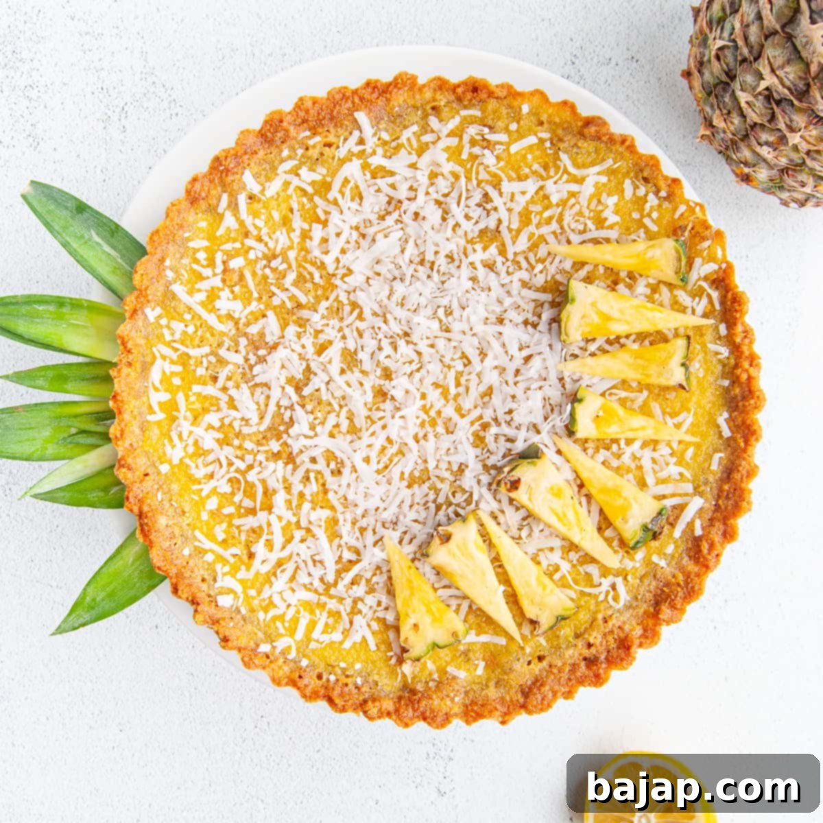 A slice of creamy pineapple pie with a graham cracker crust on a plate.