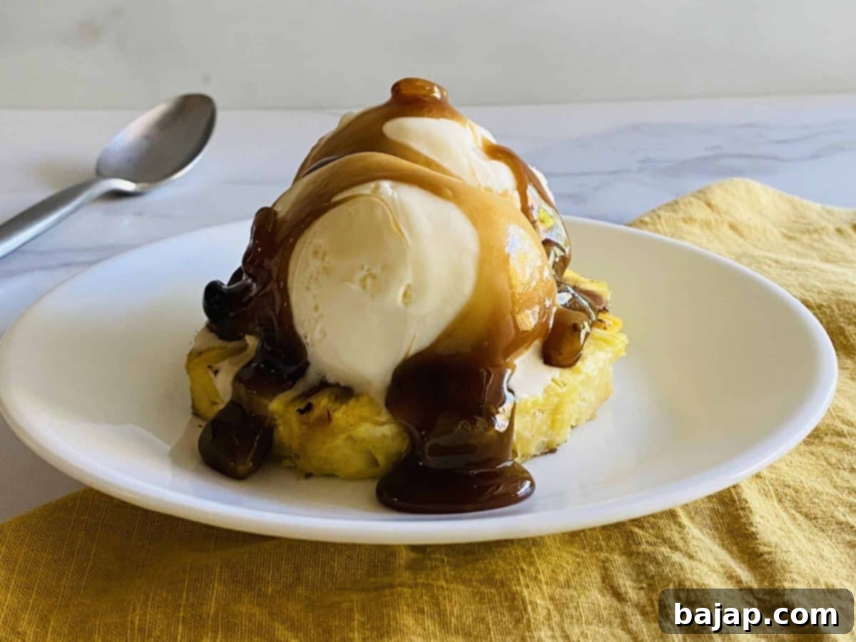 Rum raisin pineapple sundaes in glass dishes, garnished with mint.