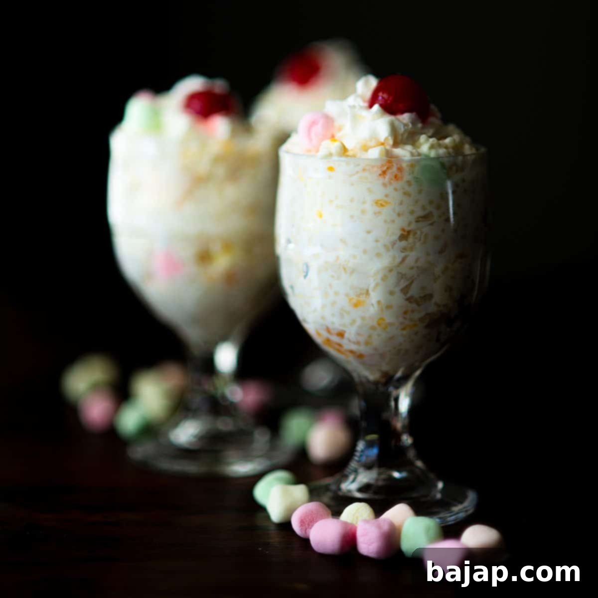A bowl of creamy Frog Eye Salad with mini marshmallows and fruit.