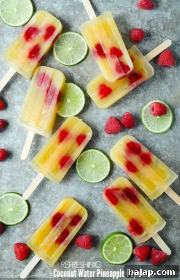 Refreshing coconut water pineapple popsicles on a wooden board.