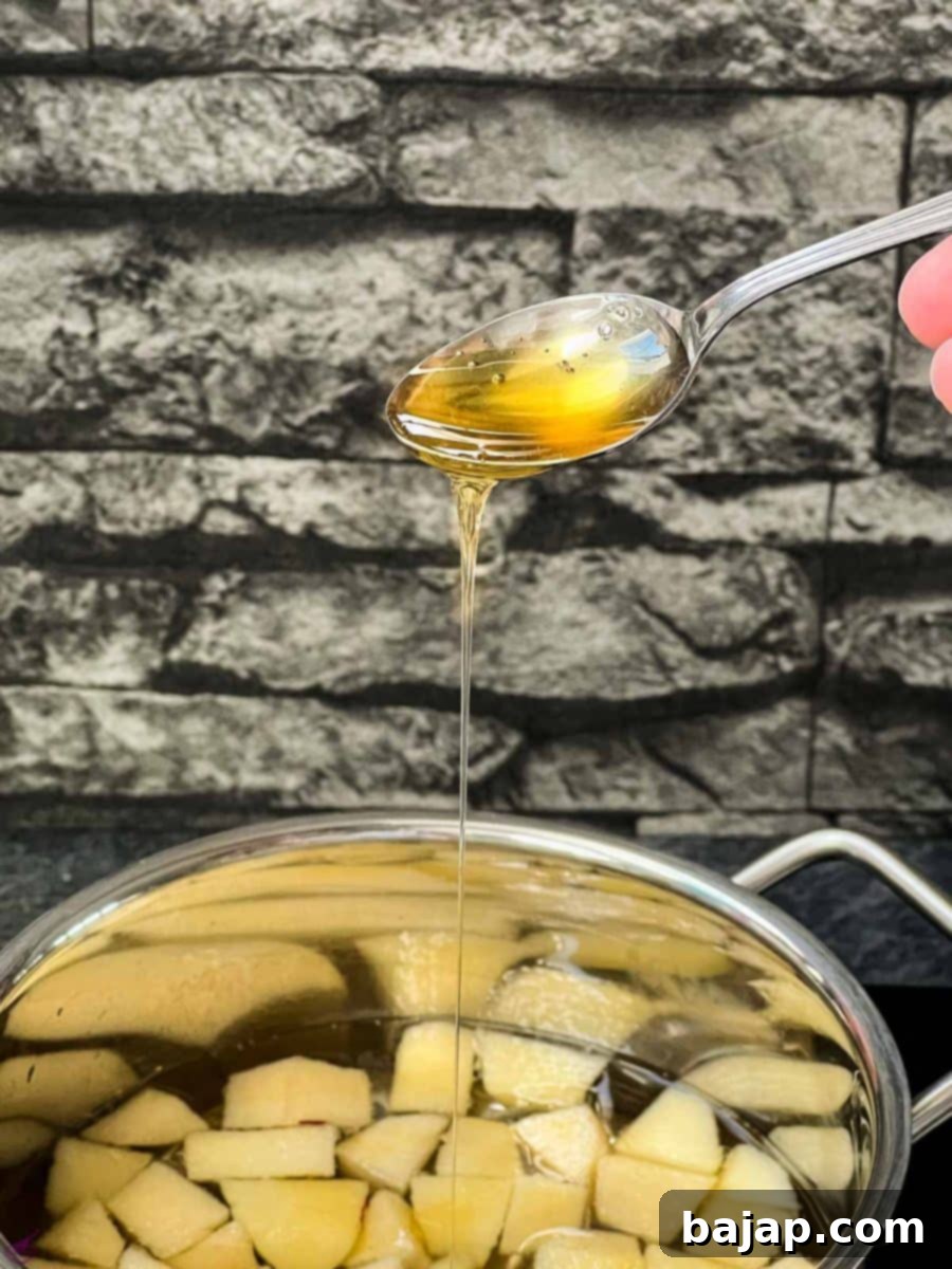 Honey dripping from a teaspoon. 