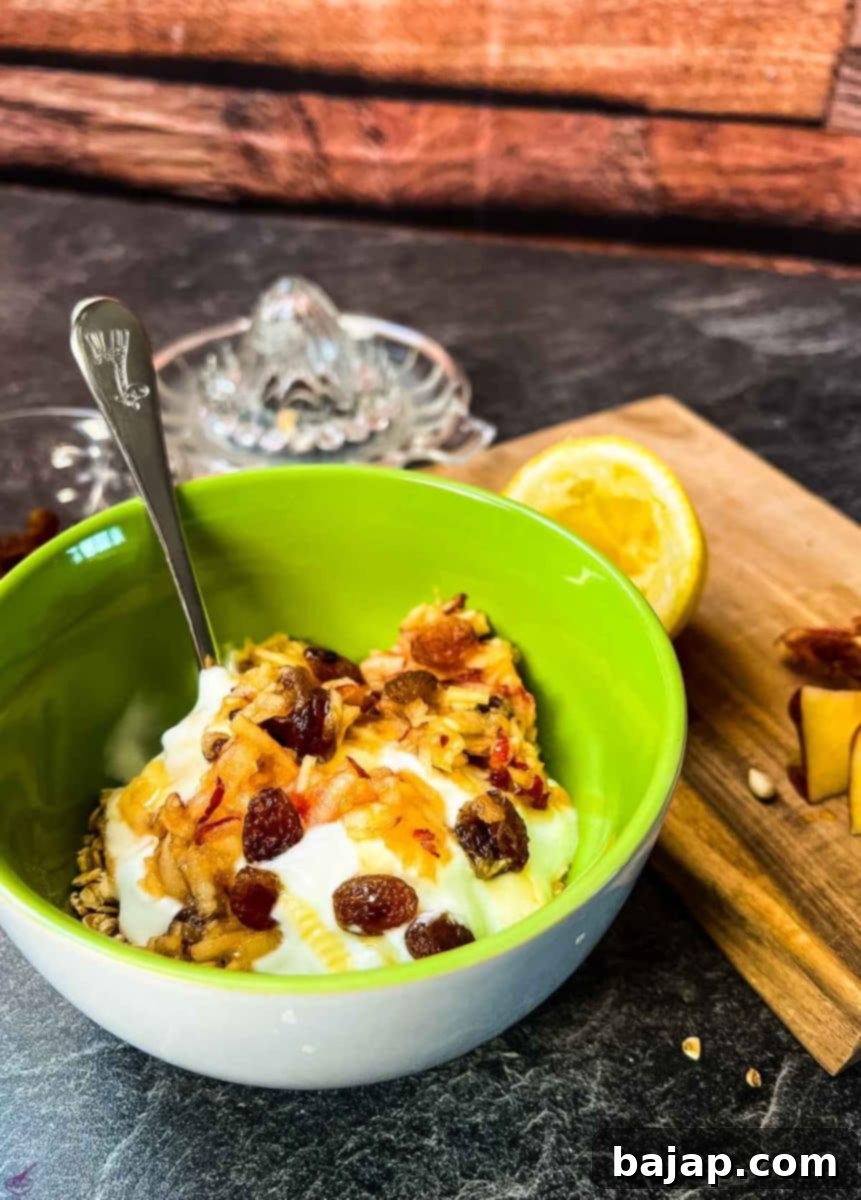 Breakfast bowl with grated apples, raisins, yogurt, honey and rolled oats. 