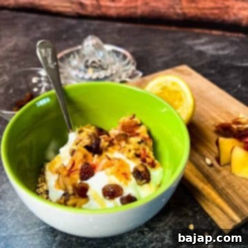 Breakfast bowl with grated apples, raisins, yogurt, honey and rolled oats.