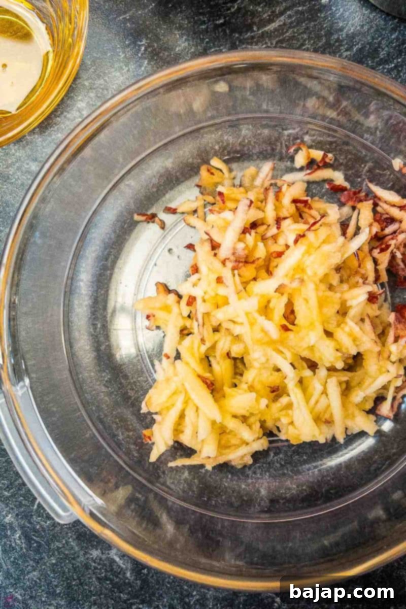 Grated apples in plastic bowl. 