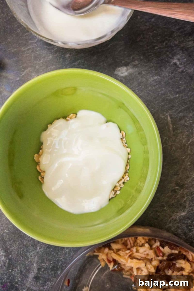 Bowl filled with rolled oats and a layer of yogurt.