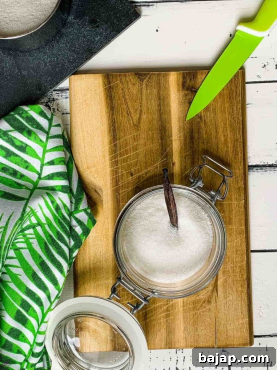 Adding vanilla bean to preserving jar filled with granulated sugar.
