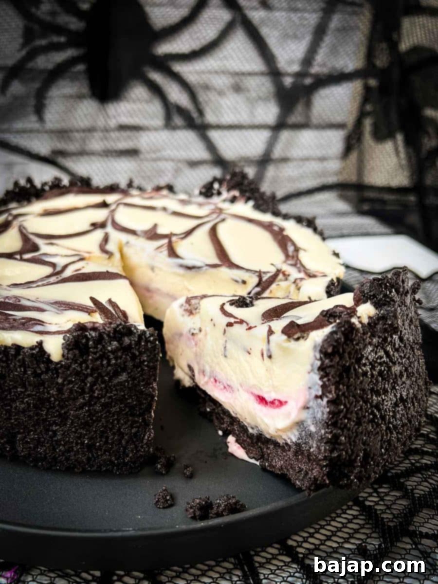 Slice of no bake raspberry Oreo cheesecake on a black plate. 