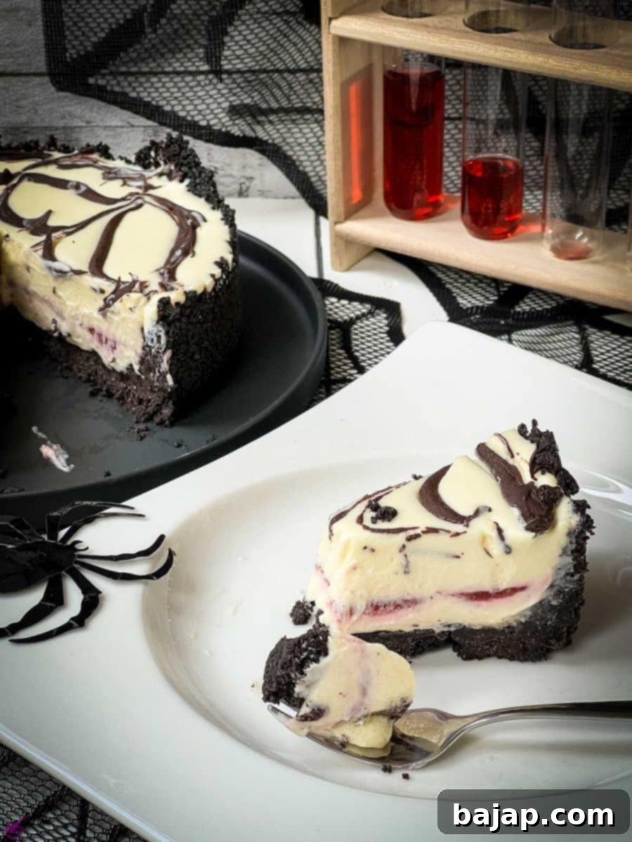 Slice of no bake raspberry Oreo cheesecake on white plate. 