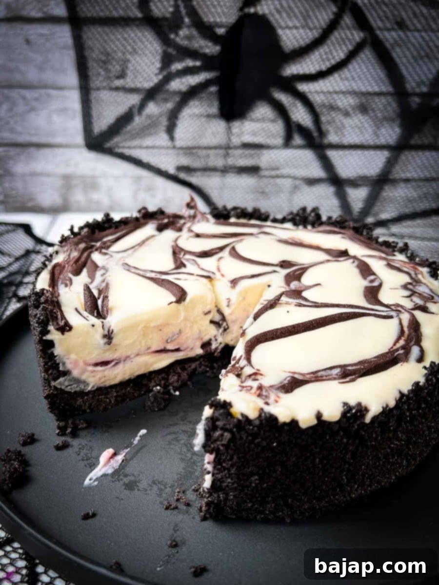No bake raspberry Oreo cheesecake on a black plate. 