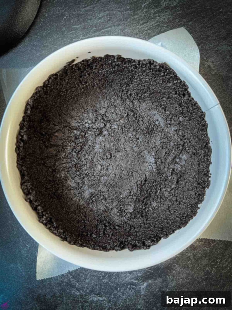 Oreo dough pressed firmly into the springform pan. 
