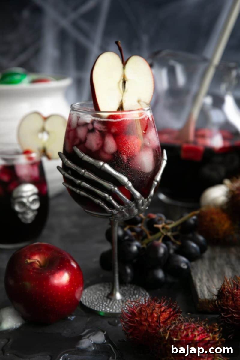 Black Magic Halloween Sangria, a spooky red wine cocktail with vodka, raspberry liqueur, and fresh fruit.