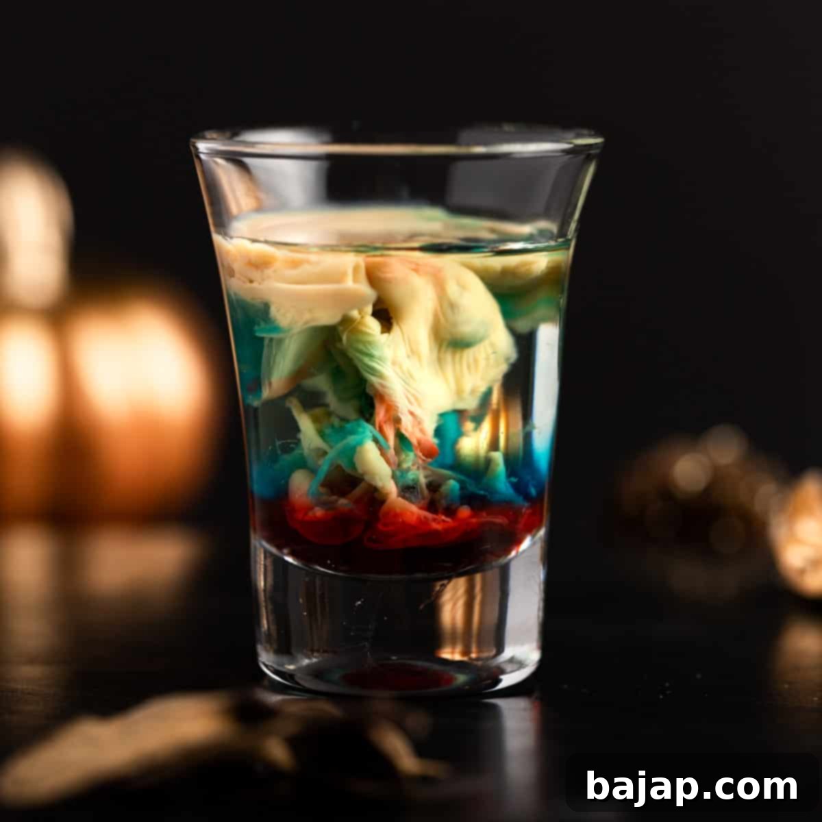 Alien Brain Hemorrhage Shot, a creepy multicolored Halloween shot with Peach Schnapps, Baileys, blue curaçao, and grenadine.