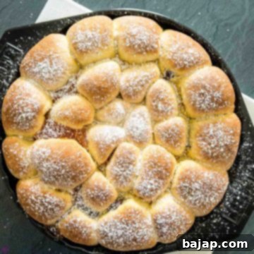 Finished baked Buchteln sprinkled with powdered sugar and ready to be eaten.