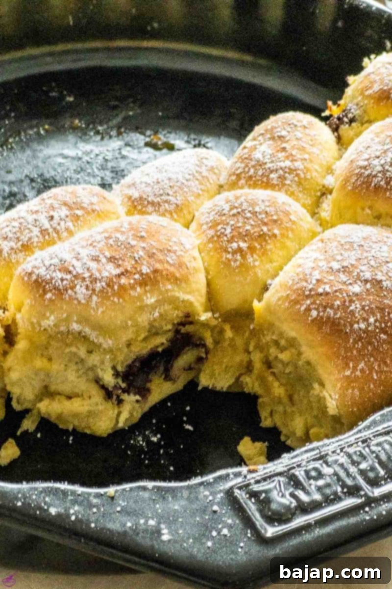 Pull-apart style Buchteln, freshly baked and sprinkled with powdered sugar, ready to be enjoyed.
