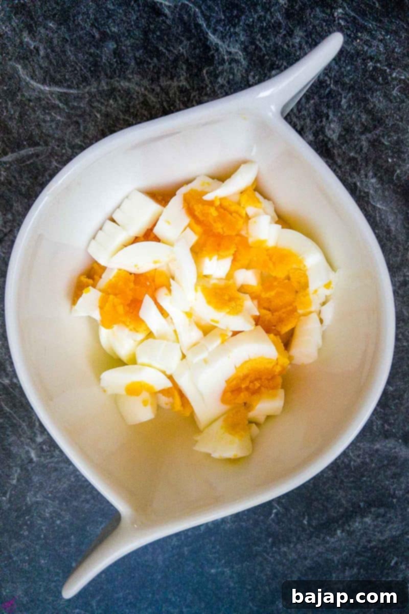 Egg quartered in white bowl.