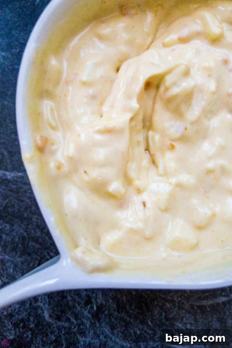 White bowl with egg salad spread.